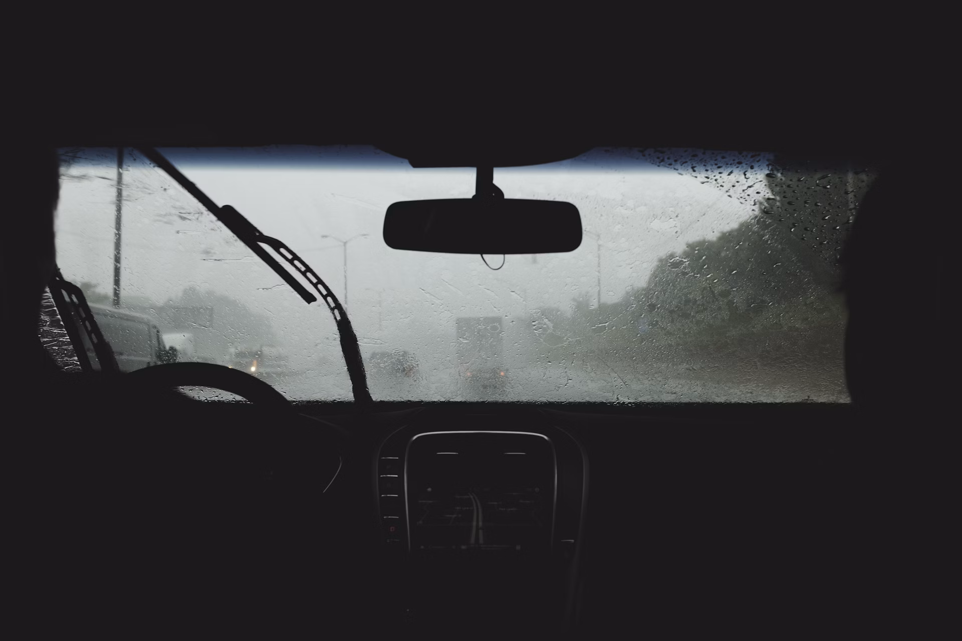 two person driving on rainy road