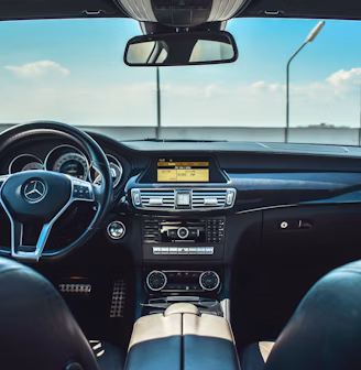 black Mercedes-Benz vehicle steering wheel